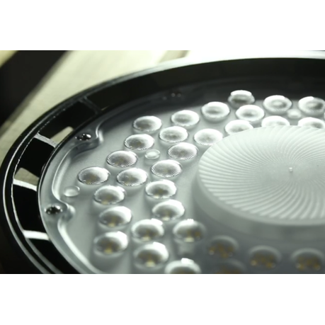 Close-up of a shower head with water droplets on a white background